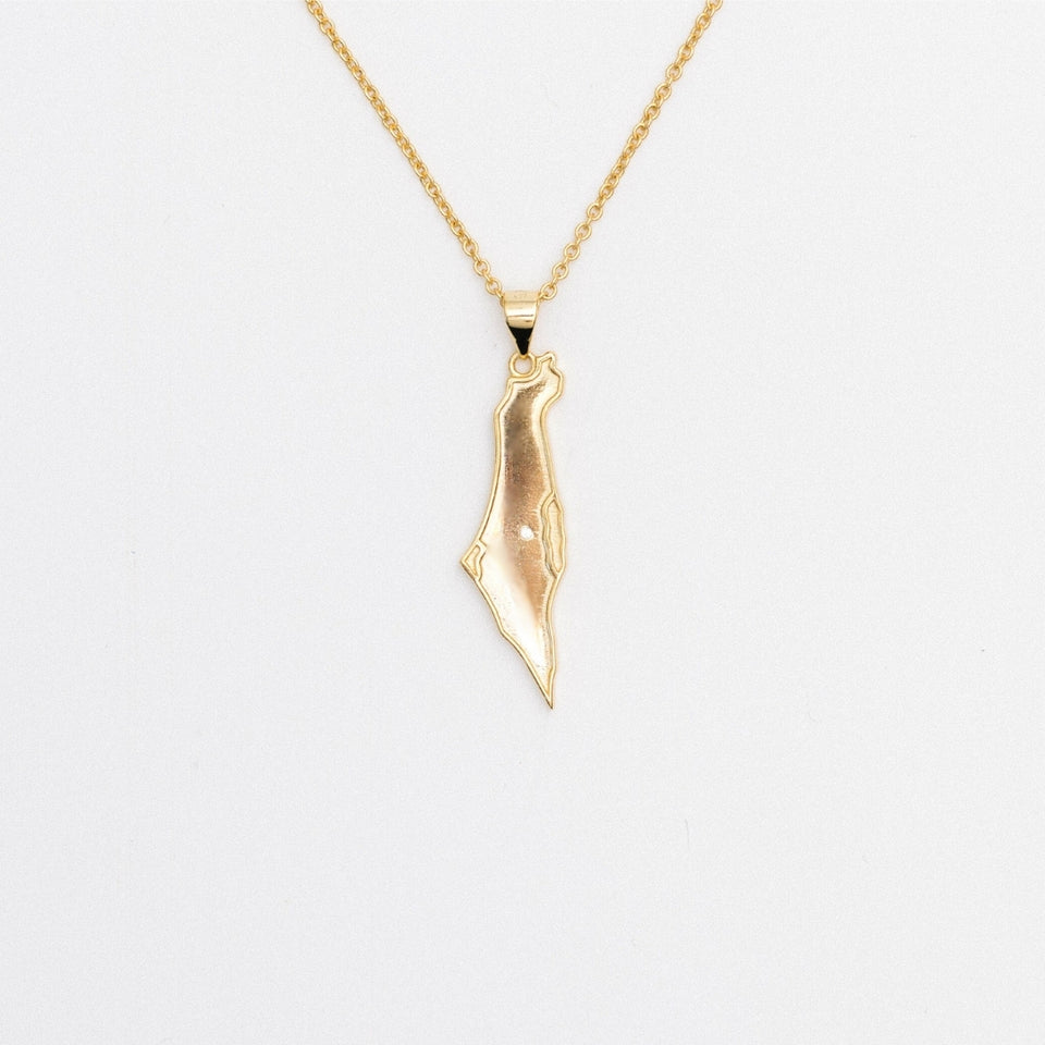 A gold-colored necklace featuring a map of Israel pendant with a gemstone representing Jerusalem.